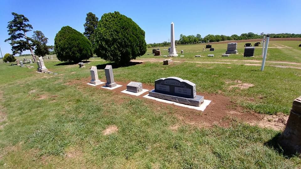 A cemetery with a lot of graves and trees