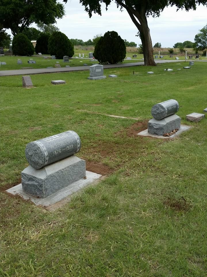 Graves in a cemetery with a tree in the background