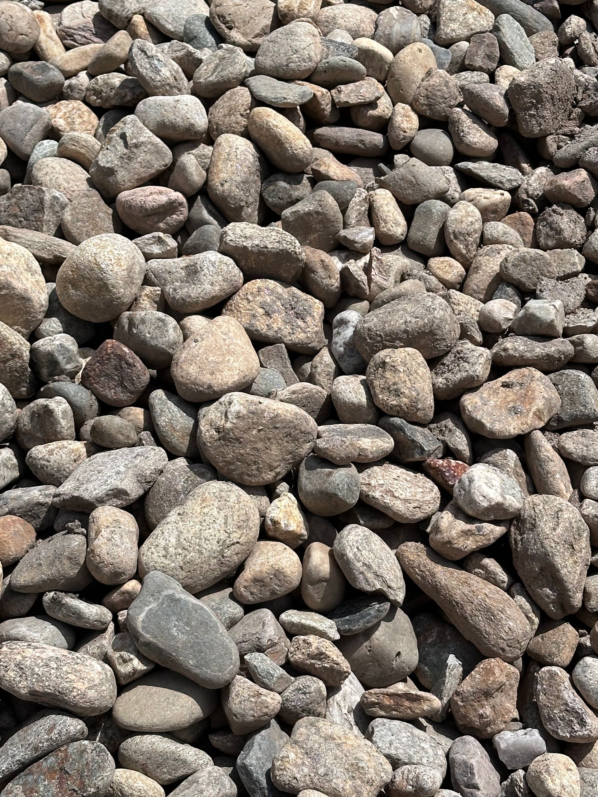 A pile of gravel is sitting on top of a tarp.