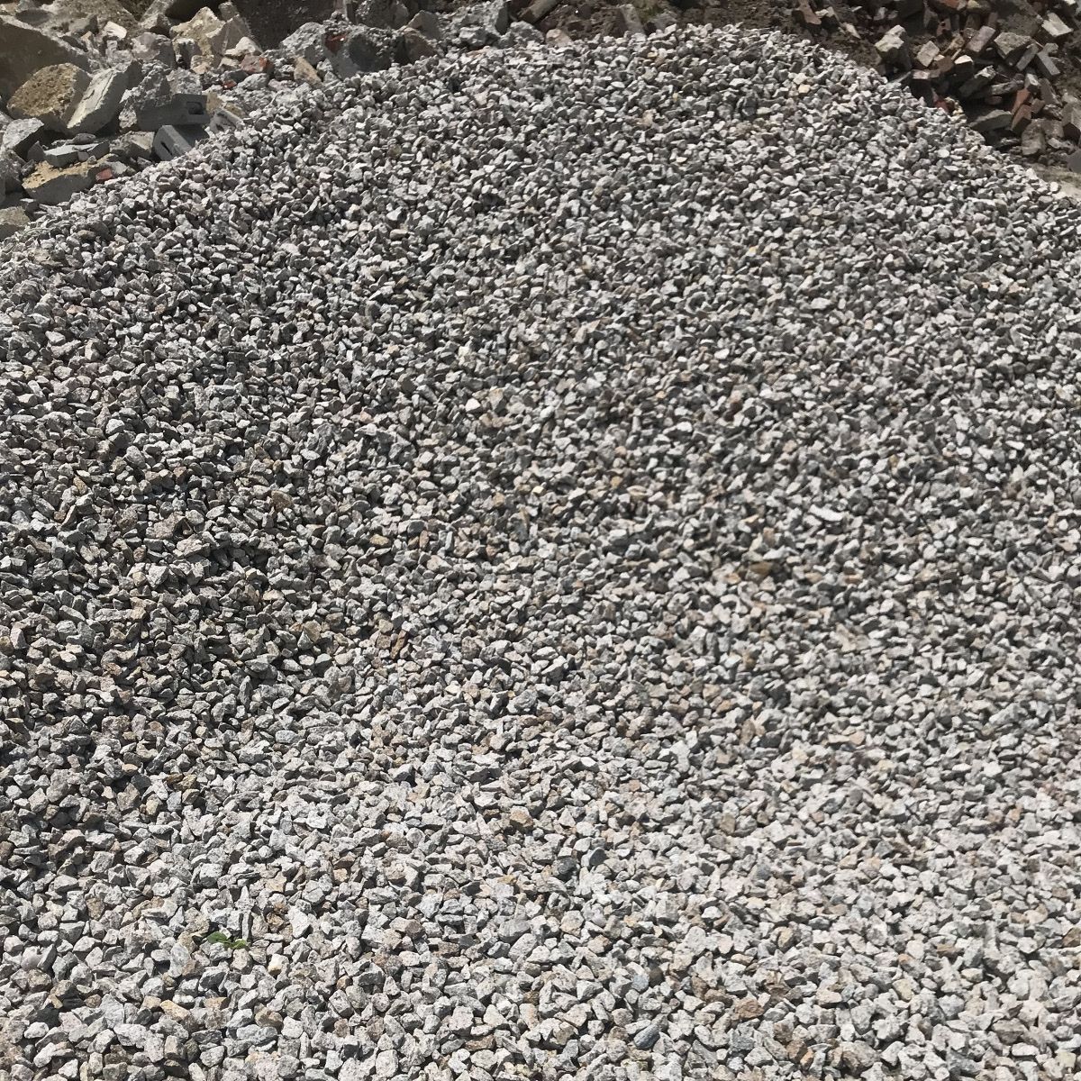 A pile of gravel is sitting on top of a pile of rocks.