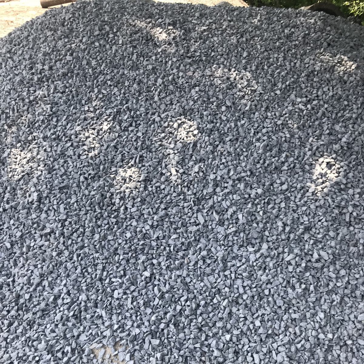 A pile of gravel is sitting on the ground.