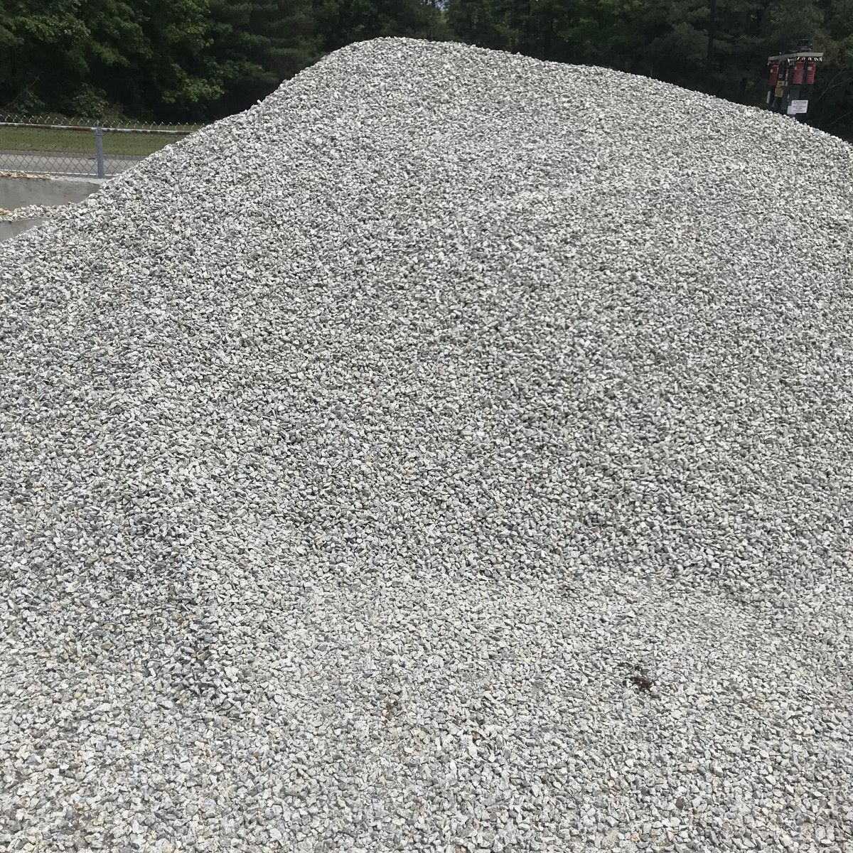 A large pile of gravel is sitting on the ground.