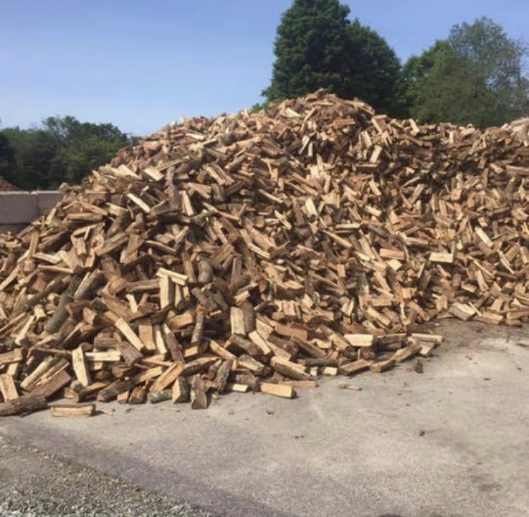 A large pile of wood is sitting on the ground