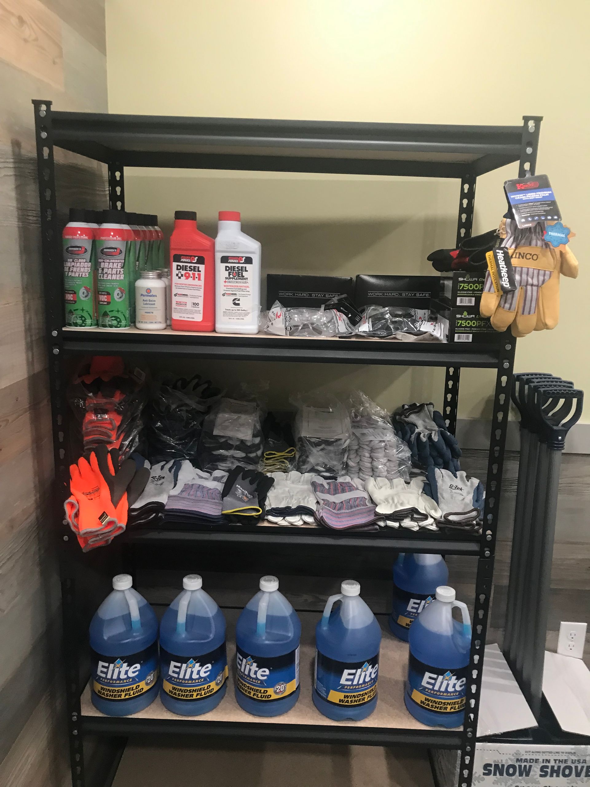A shelf filled with bottles of water and other items.