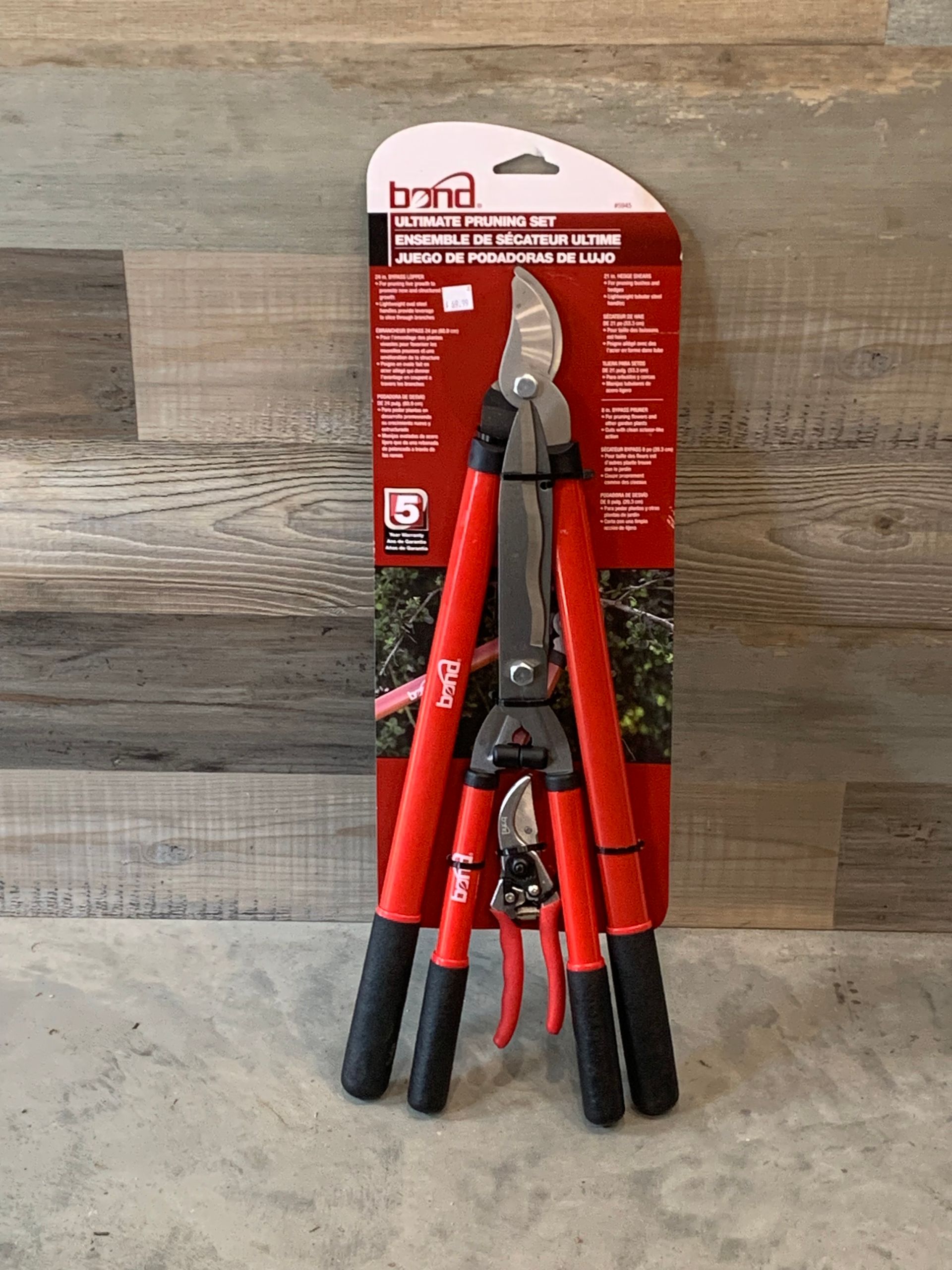 A pair of red and black pruning shears in a package