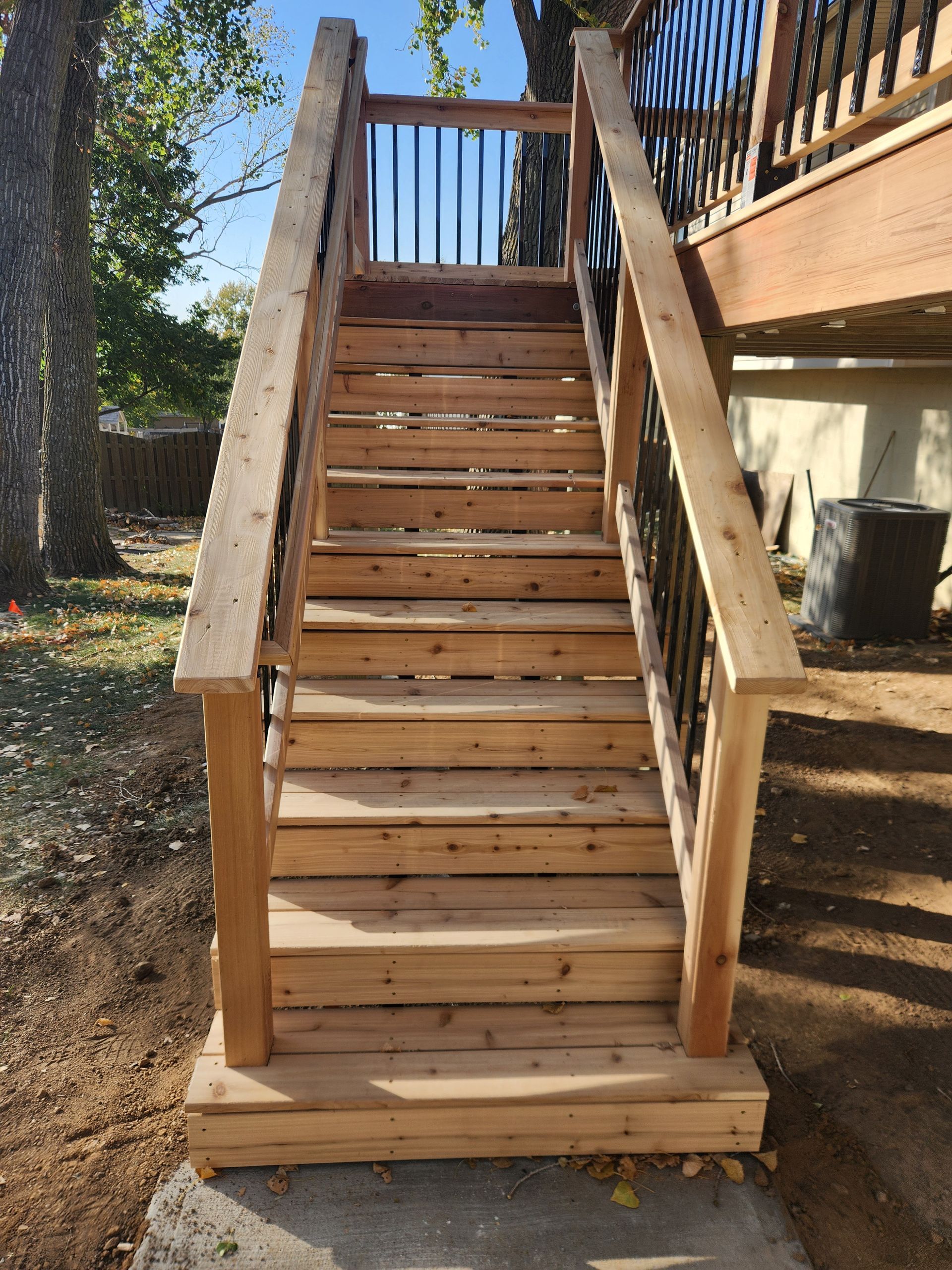 A set of wooden stairs leading up to a deck.