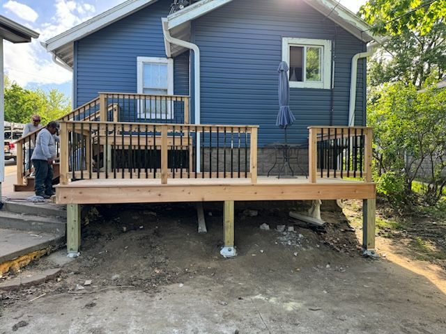a wooden deck in front of a blue house