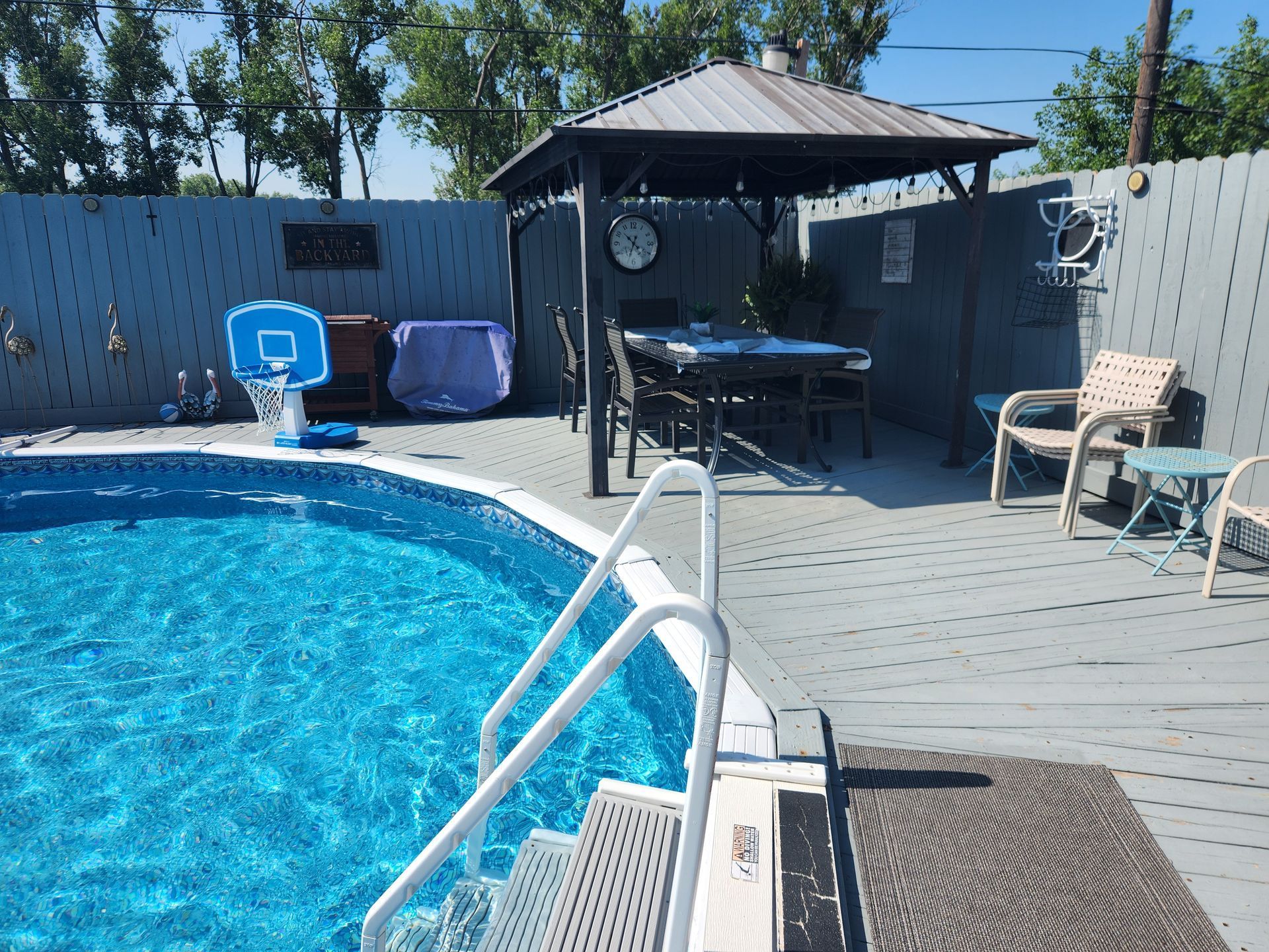 A swimming pool with a gazebo in the background