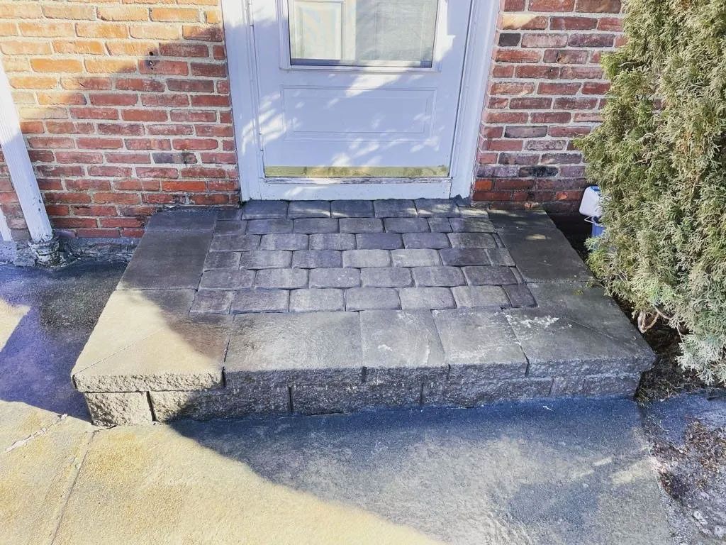 Brick home doorway with a stone step.