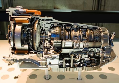 A cut-in-half model of a car engine on display