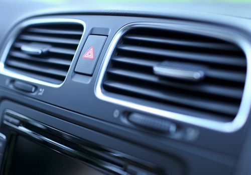 A close-up of the air vents on the dashboard of a car.