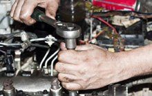 mechanic repairing transmission