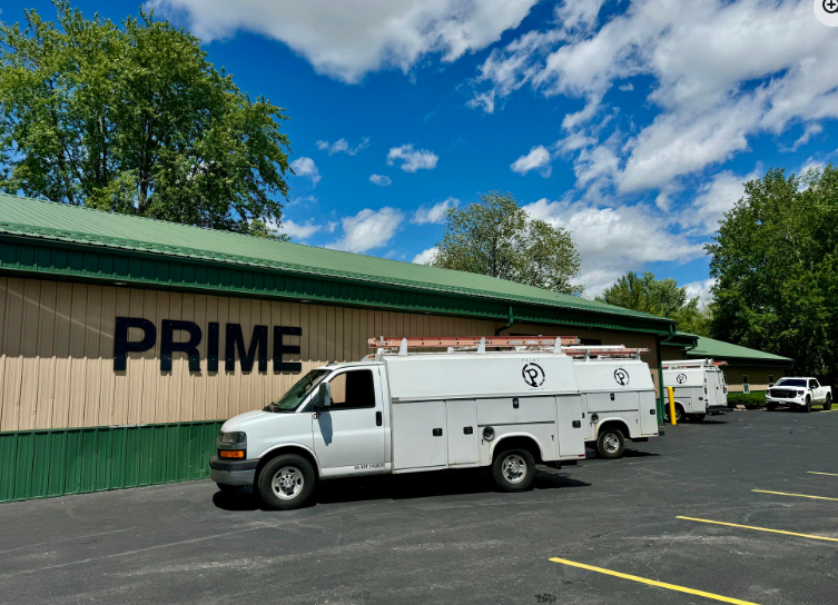 White trucks parked outside a building with 