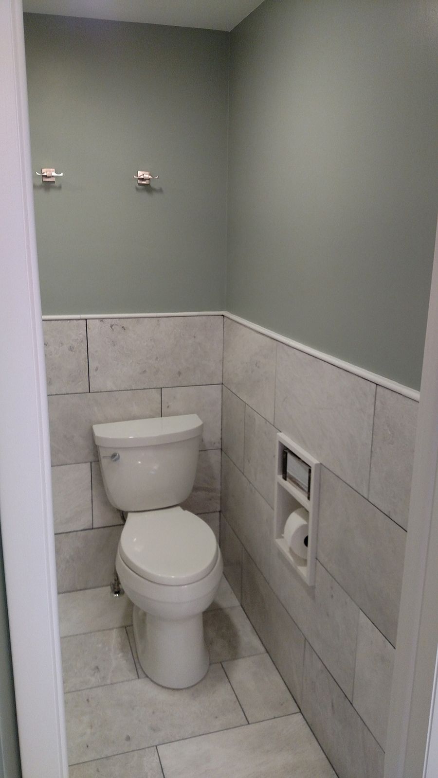 Small bathroom with gray walls, white tile, and a toilet.