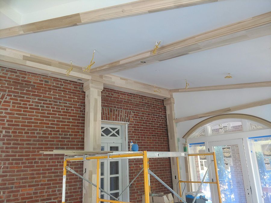 Interior brick wall with wood framing and scaffolding.