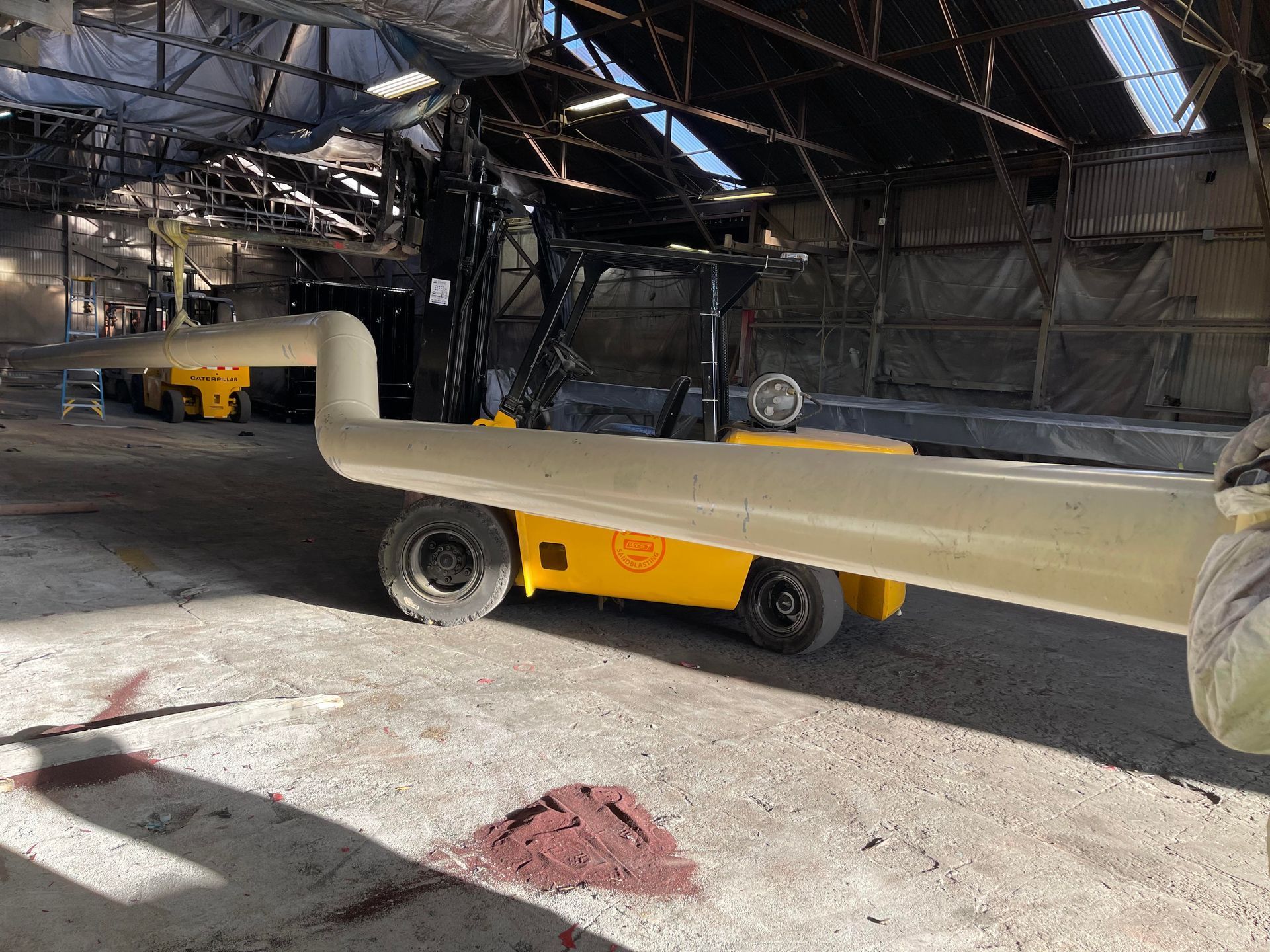 Small flatbed trailer inside a warehouse