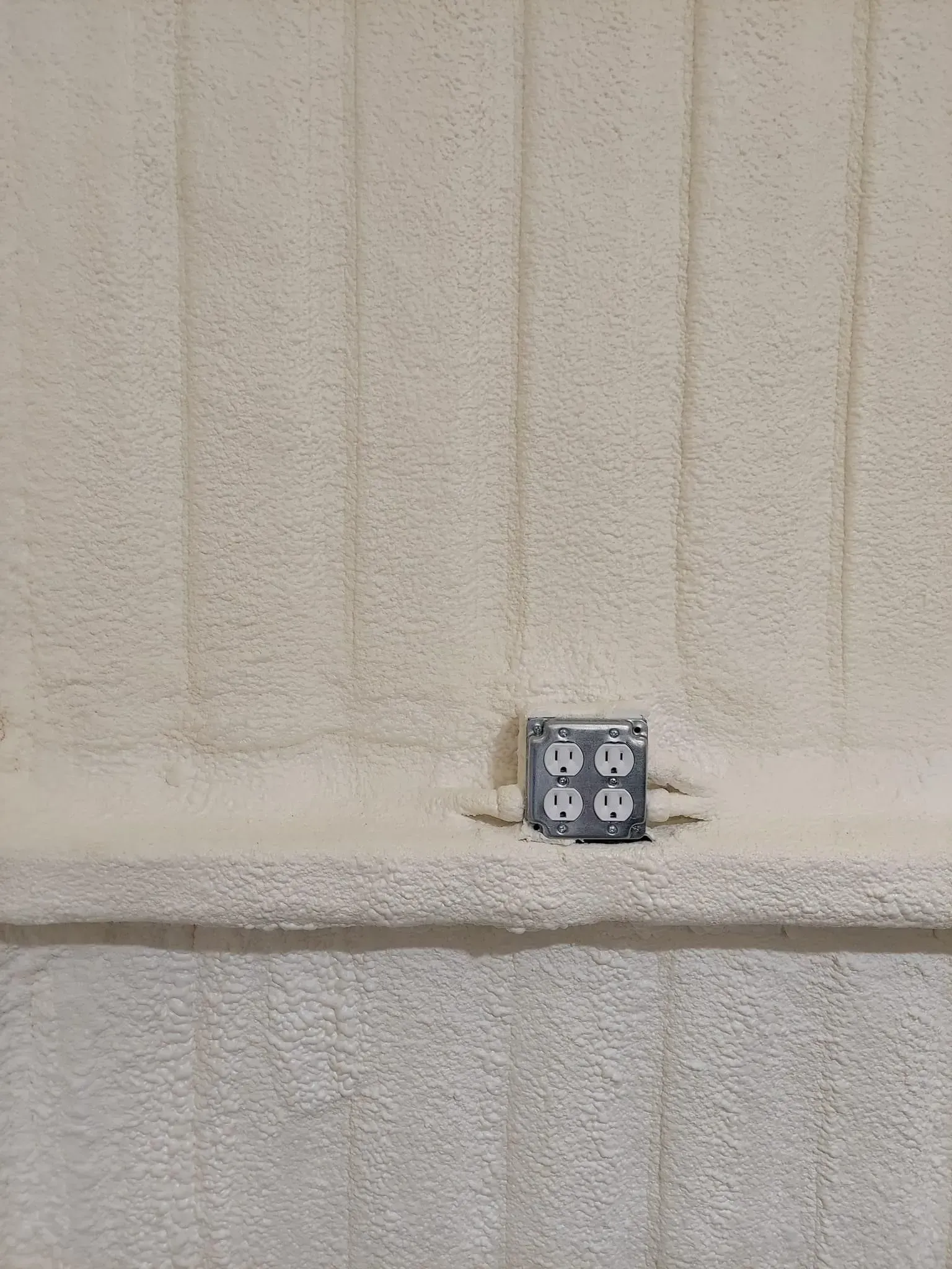 A multi-port electrical outlet box on a cream-colored carpet.