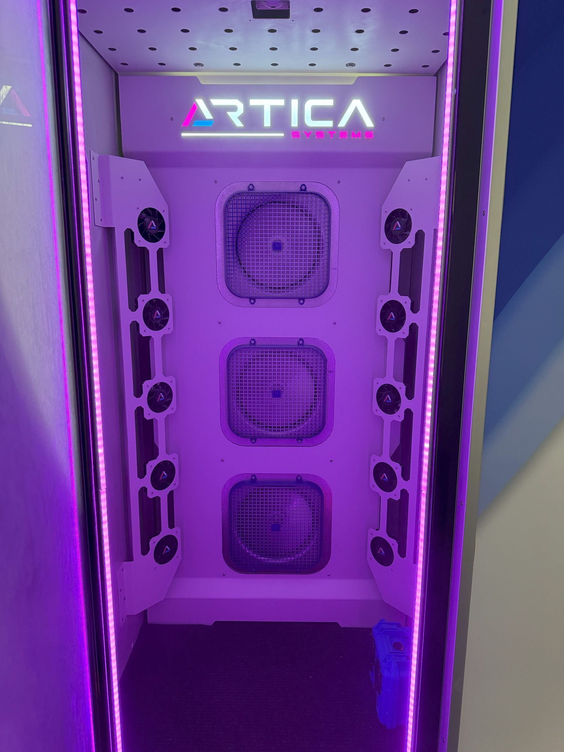 White Artica machine with purple lighting, three square vents, and speaker arrays.