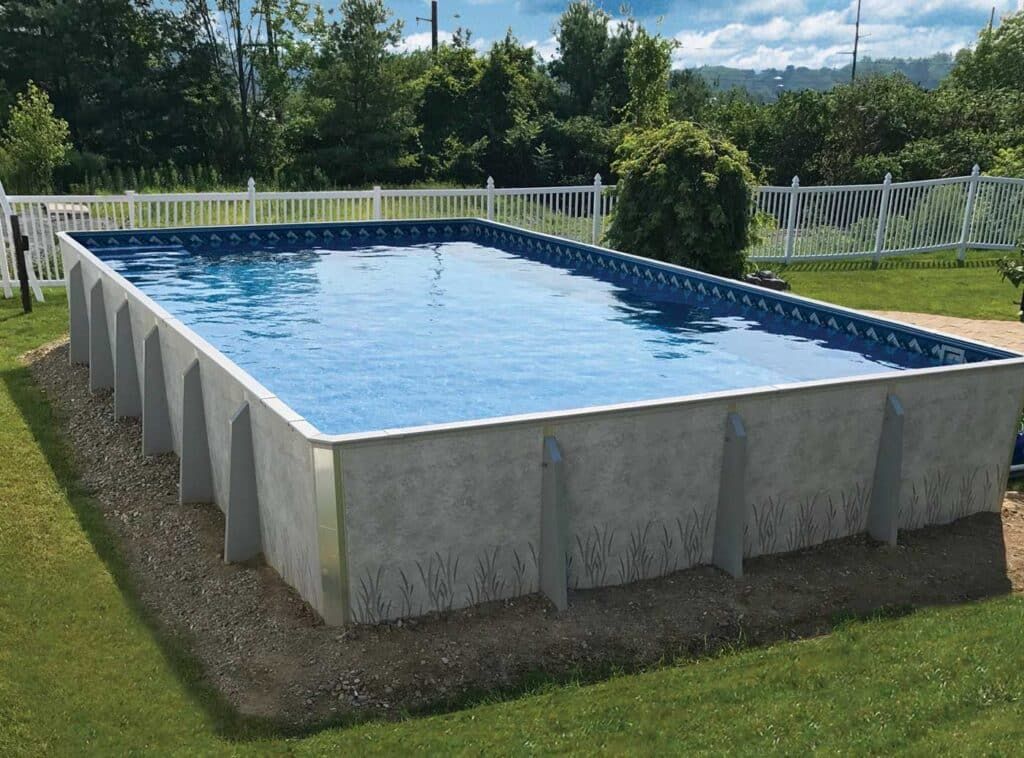Rectangular above-ground pool with clear blue water in a grassy yard beside a white fence