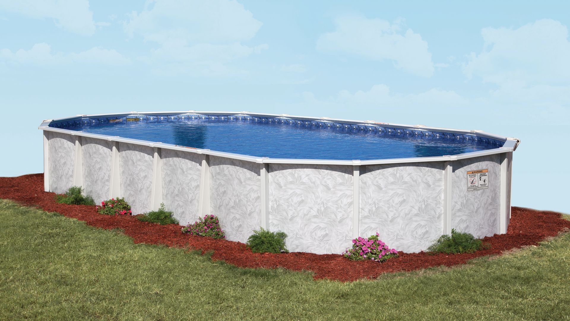 Above-ground oval pool with blue water, white sides, and red mulch on a grassy lawn