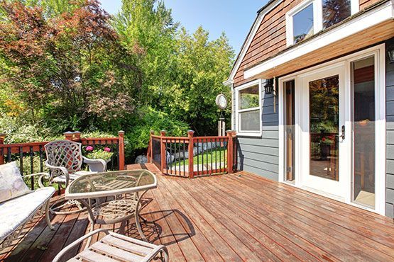 A patio deck with table and chairs