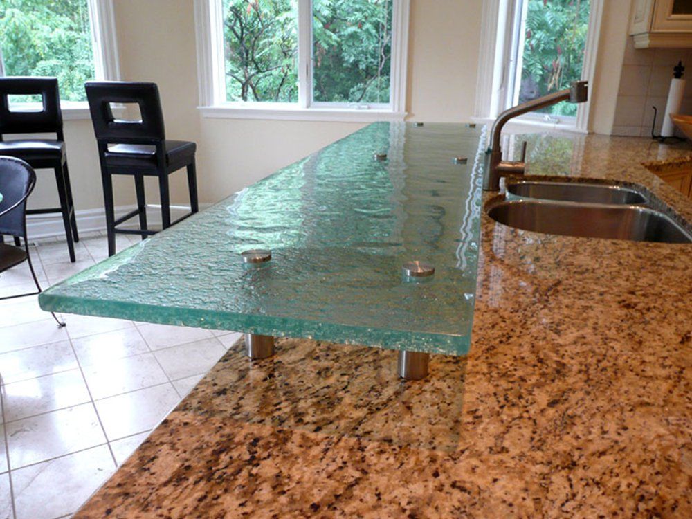 A kitchen with granite counter tops and a glass counter top