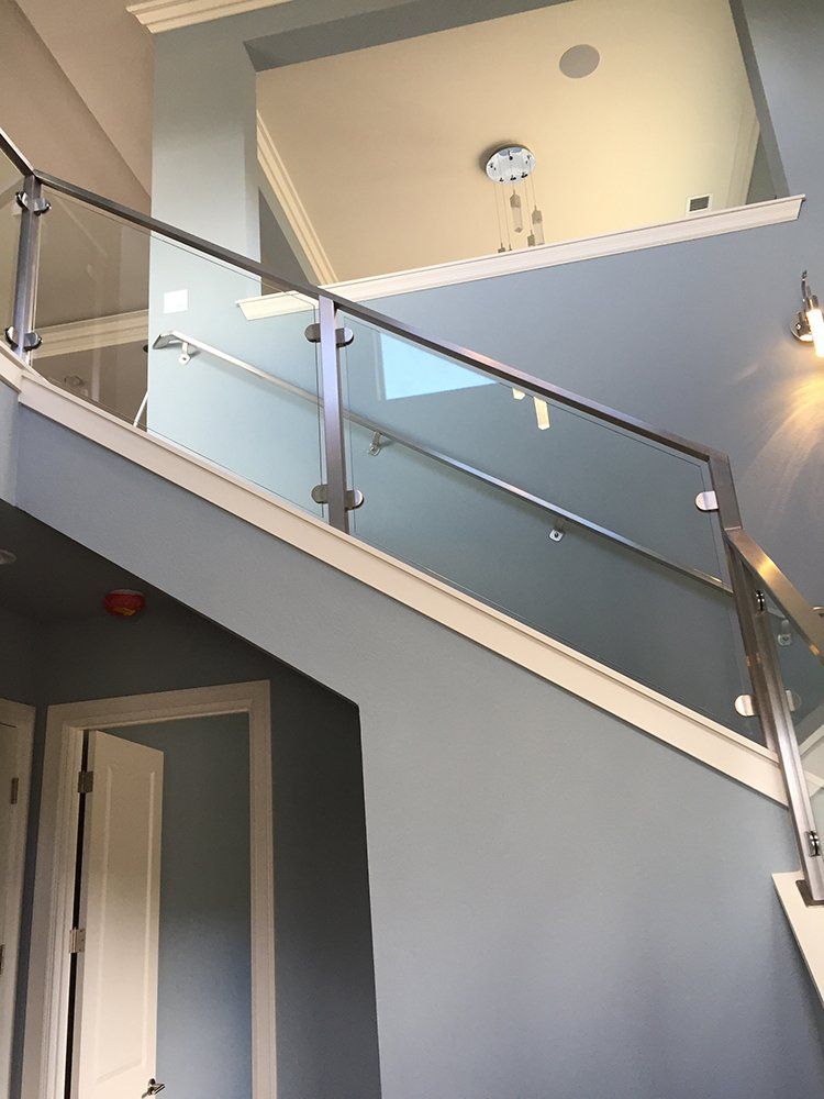 A staircase with a glass railing in a house