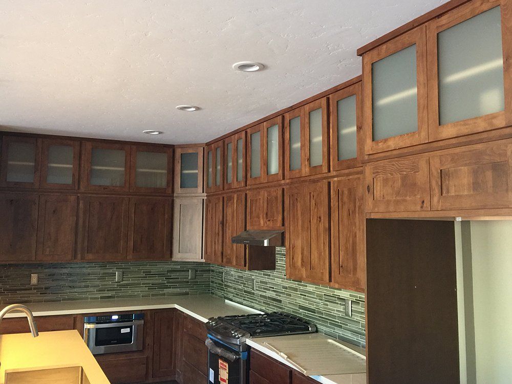 A kitchen with wooden cabinets and stainless steel appliances