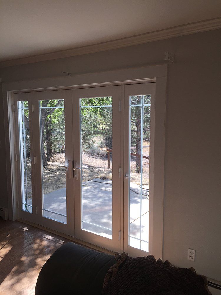 A living room with a lot of windows and a couch