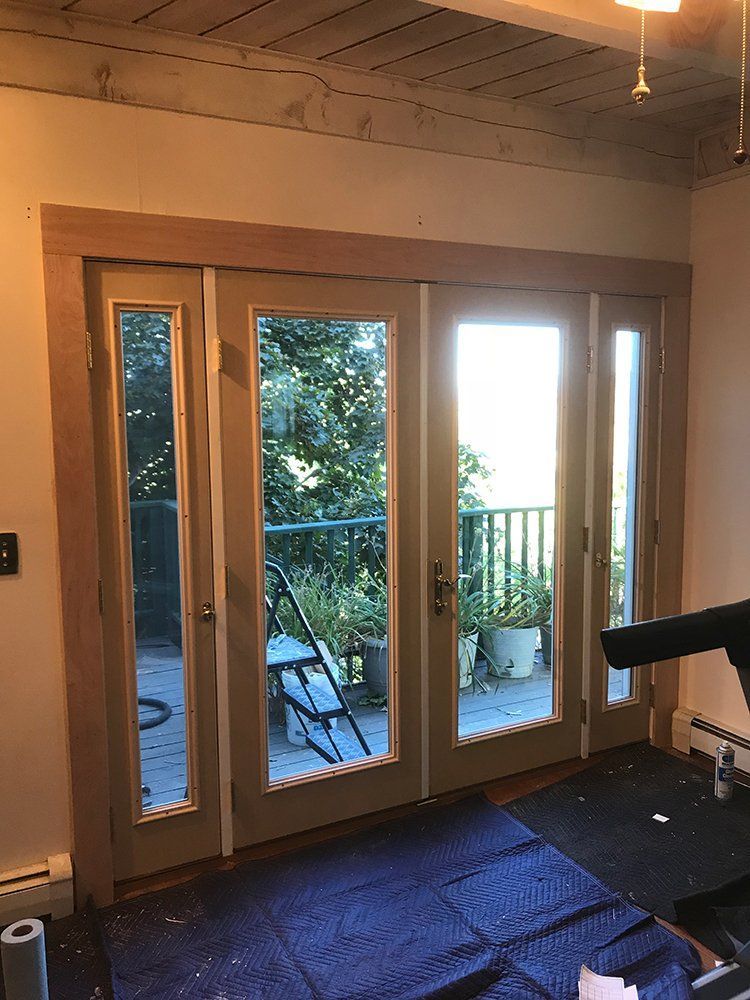 A room with a lot of windows and a balcony