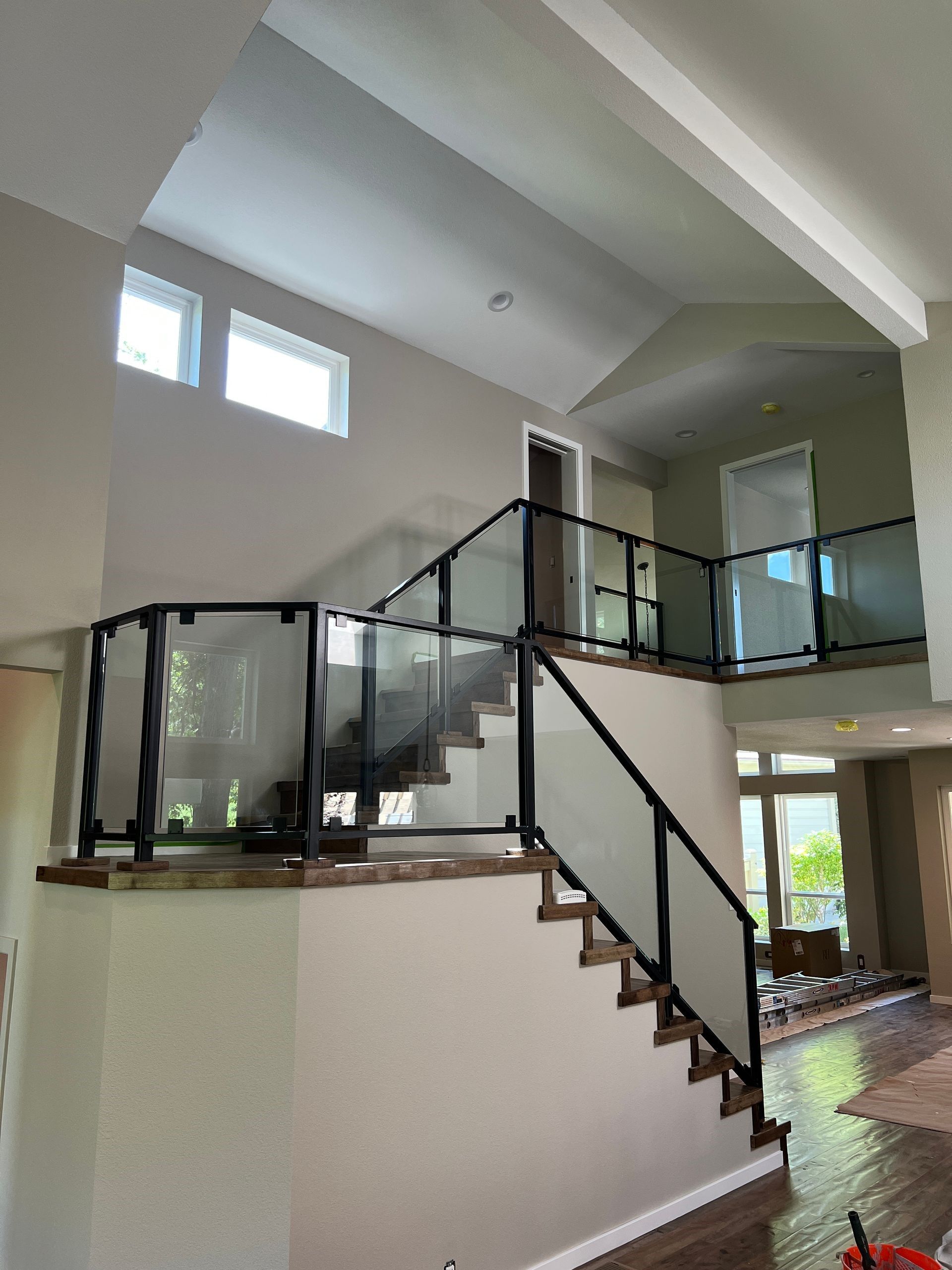 A staircase with a glass railing in a house.