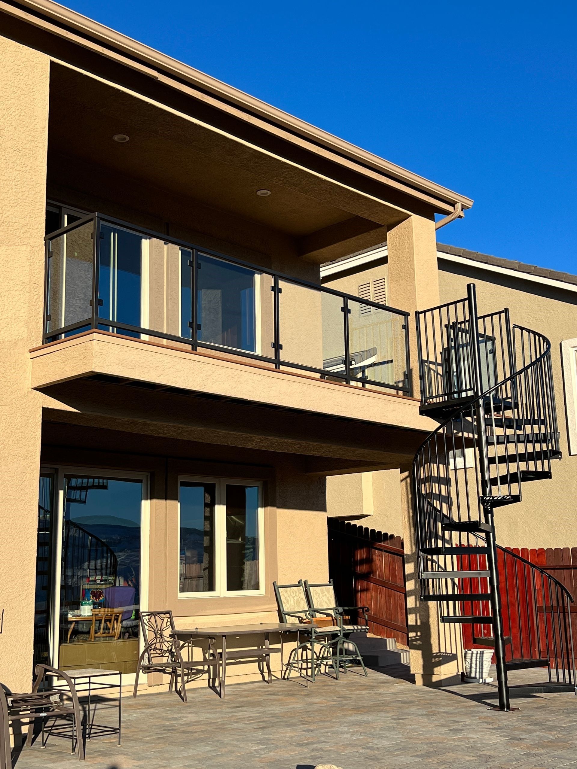A house with a spiral staircase and a glass balcony