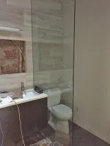 A bathroom with a glass partition