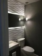 A bathroom with a toilet, sink and mirror