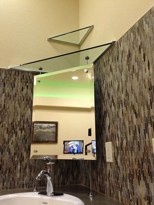 A bathroom with a sink and a mirror on the wall
