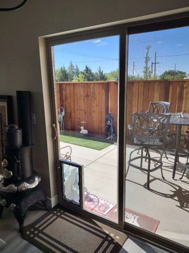 A living room sliding glass door with a pet door