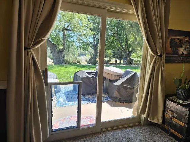 A living room sliding glass door with a pet door