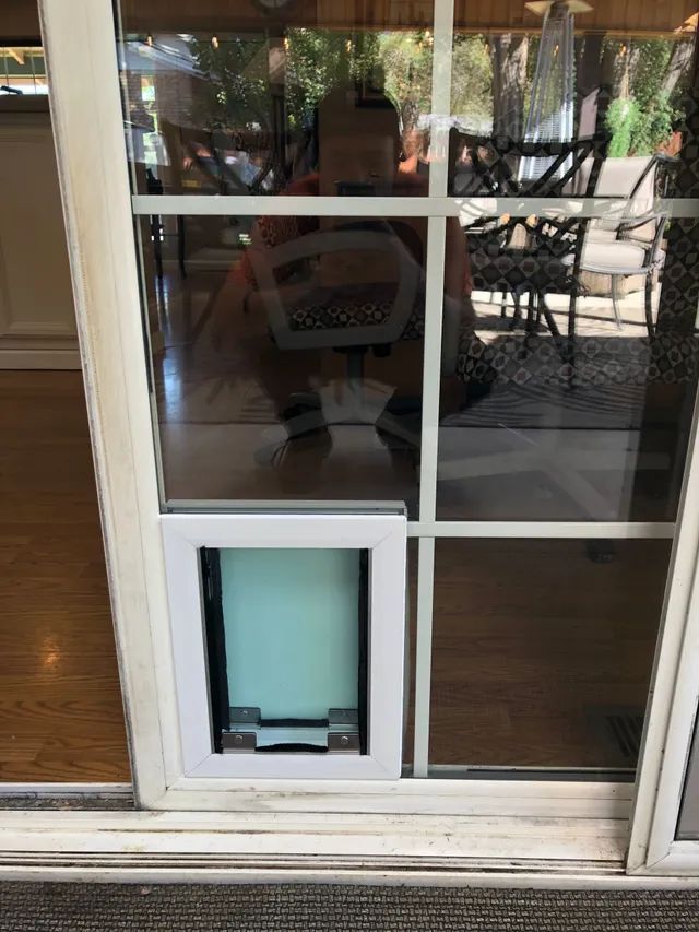 A sliding glass door with a pet door installed