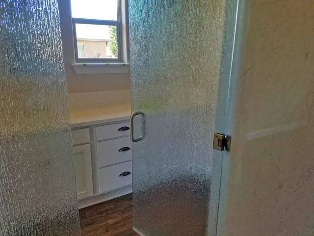 A bathroom with a glass shower door