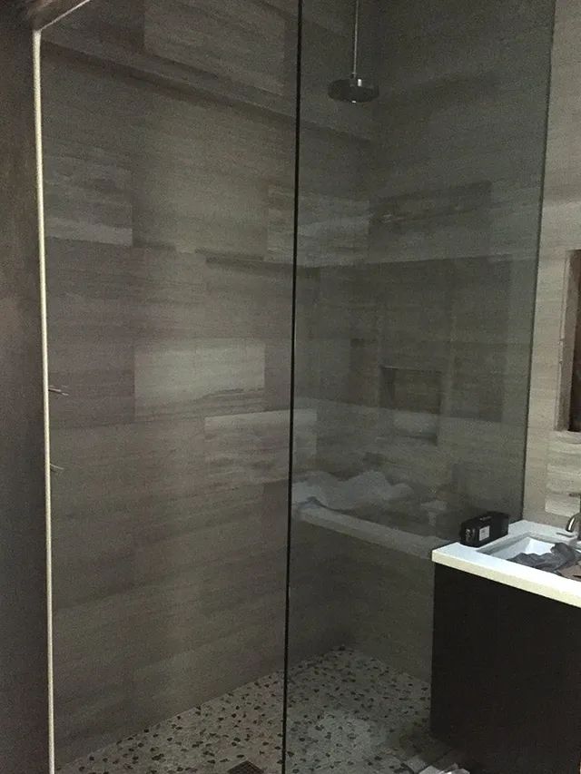 A bathroom shower with a glass enclosure