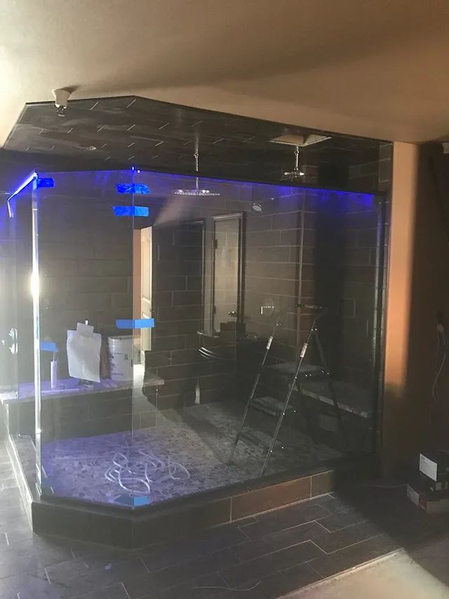 A bathroom under construction with a glass wall and a ladder in it