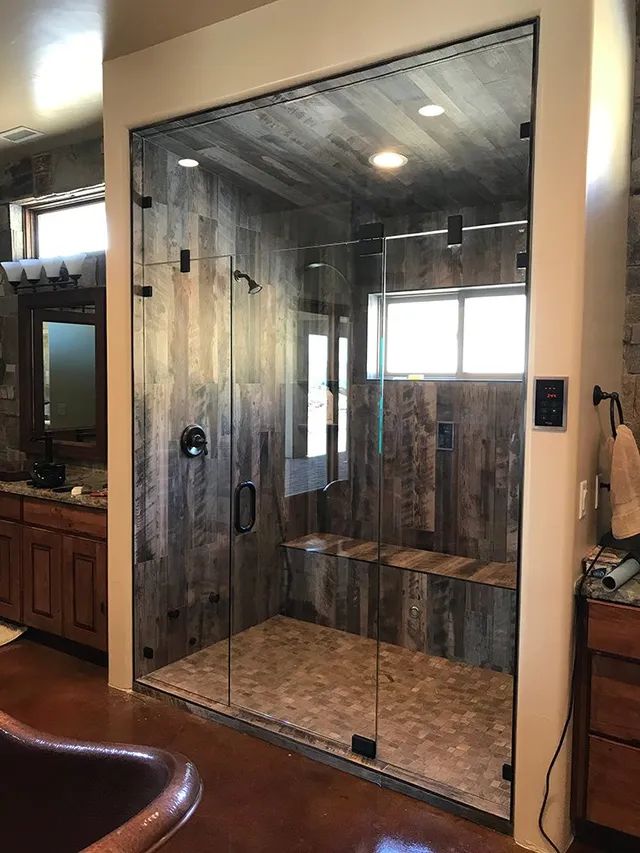 A bathroom with a walk-in shower and a bathtub