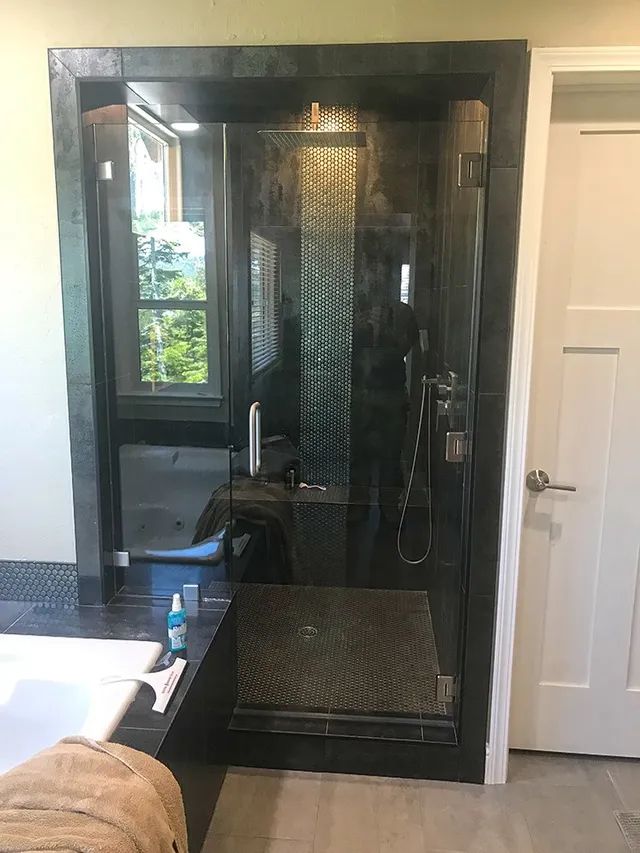 A bathroom with a walk-in shower and a bathtub