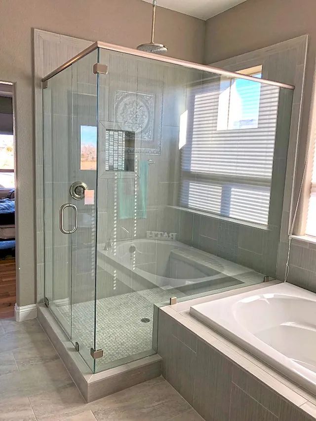 A bathroom with a walk-in shower and a bathtub