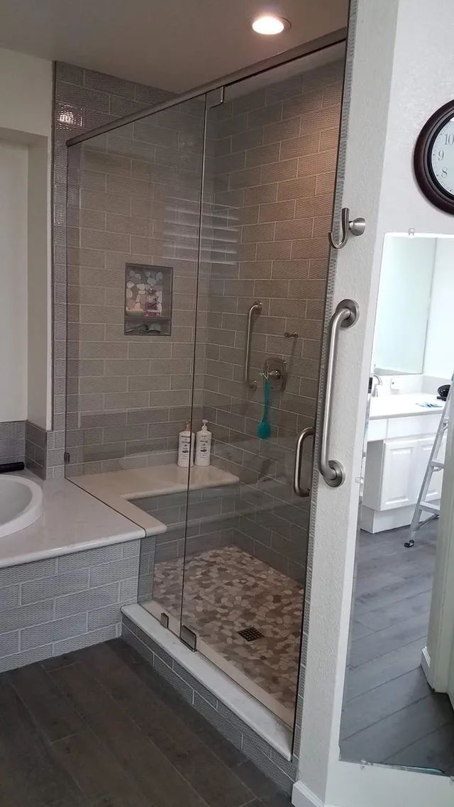 A bathroom with a walk-in shower and a bathtub