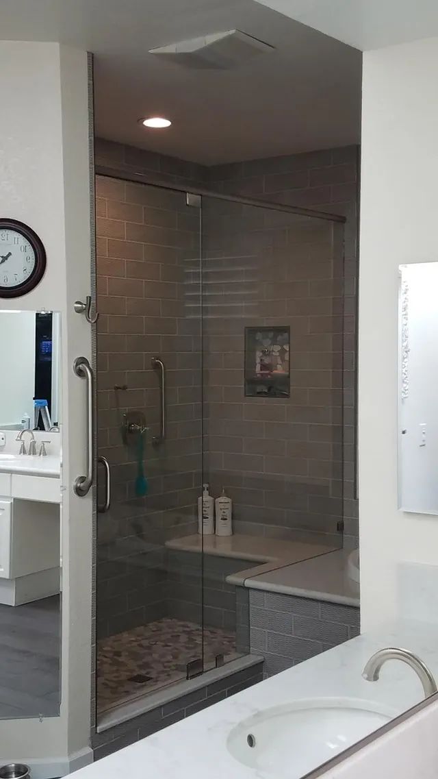 A bathroom with a walk-in shower and a bathtub