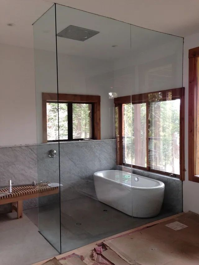 An unfinished installation of a bathroom shower with a tub