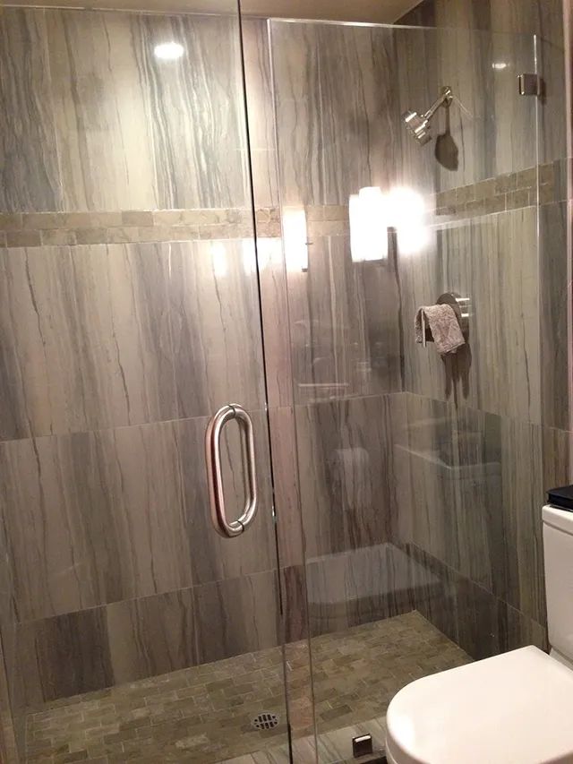 A bathroom with a glass shower door