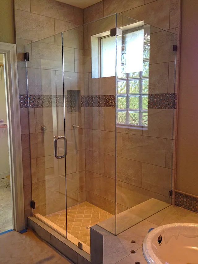 A bathroom with a glass shower door