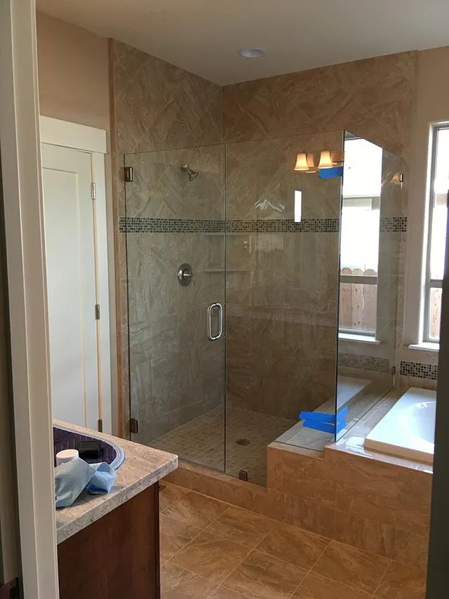 A bathroom with a walk-in shower and a bathtub